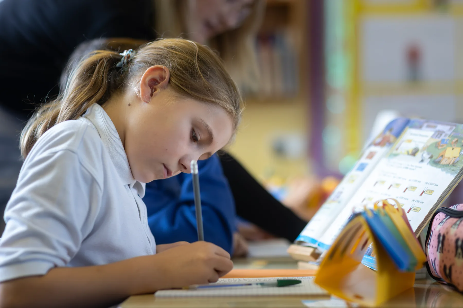 A pupil concentrating on written classroom work